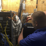 Network technician installing electronics